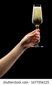 Woman Hand Holding Glass Of Sparkling Champagne Isolated On Black Background.