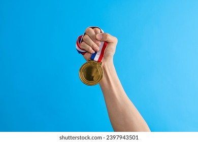 Woman hand holding a gold medal. - Powered by Shutterstock