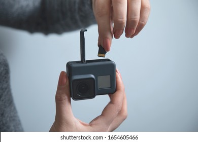 Woman Hand Holding Gopro On Grey Wall Background