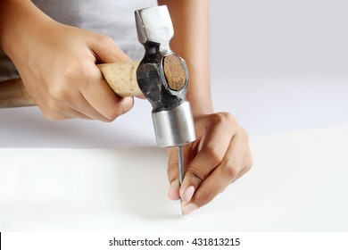 Woman Hand Holding Hammer Hitting Nail