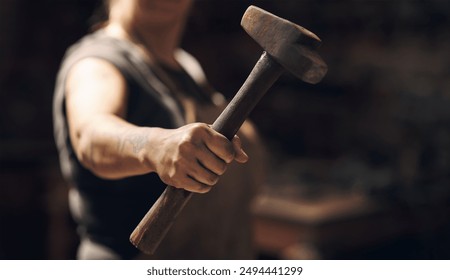 Woman, hand and holding hammer with small business for crafting metal and object at workshop. Female person, blacksmith and empowerment or affirmative action for welder work, welding and industrial - Powered by Shutterstock