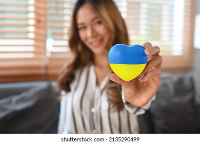 Woman hand holding heart with painted Ukraine flag.
Concept of ending the war and pray for Ukraine. - Powered by Shutterstock