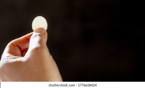 Woman Hand Holding Holy Communion To Faithful And Empty Space For Text