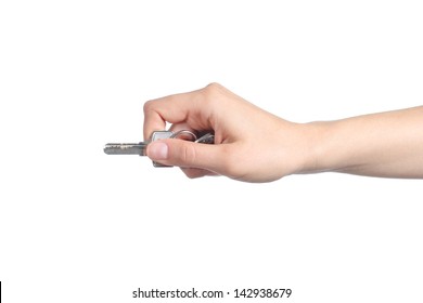 Woman Hand Holding A Home Key Ready To Open The Door Isolated On A White Background