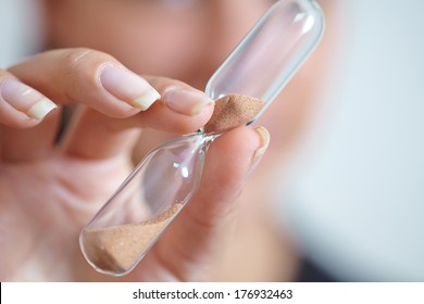 Woman Hand Holding Hourglass