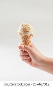 A Woman Hand Holding Ice Cream Scoop On Cone