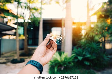 A Woman Hand Holding A Key Outside The House Plan And Decides To Buy And Move To A New Home Or Save Money For The Budget,a New Lifestyle.decide On The Best Choice, Big Sale Discount House And Housing.