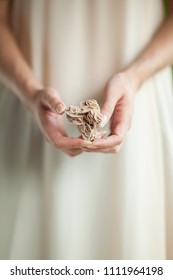 Woman hand holding little crystal mineral rock, sensual studio shot with soft light, can be used as background  - Shutterstock ID 1111964198
