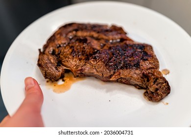 Woman Hand Holding Medium Rare Grilled Grass-fed Ribeye Rib Eye Meat Beef Steak On White Plate Serving It