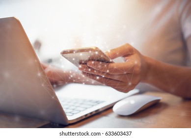 Woman hand holding mobile phone and laptop device at co-working office, She using in mobile applications and multimedia programs, Social network concept. - Shutterstock ID 633603437