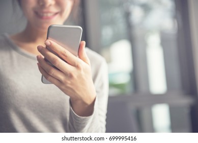 Woman hand holding mobile phone, She using in mobile applications and multimedia programs. copy space