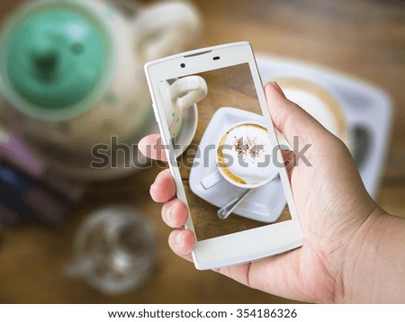 woman hand holding mobile smart phone on blur background