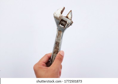 woman hand holding old rusty Spanner Mechanic tool on isolate white background