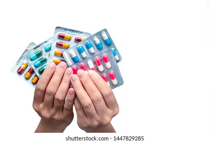 Woman hand holding pack of antibiotic capsule pills isolated on white background. Giving or receiving drug. Antibiotic drug overuse. Antimicrobial drug resistance. Pharmaceutical product. Healthcare. - Shutterstock ID 1447829285