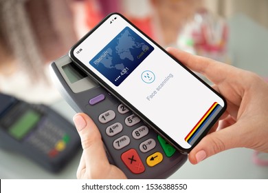 Woman Hand Holding Phone With Face Scanning Id And Payment Purchase On Pay Pass Online Terminal