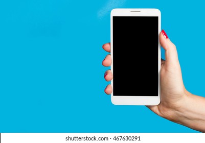 Woman Hand Holding The Phone On Blue Background