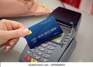 Woman Hand Holding Plastic Card And Pay Pass Online Terminal Shopping At A Store