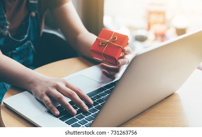 Woman hand holding red gift box about shopping online concept. - Powered by Shutterstock