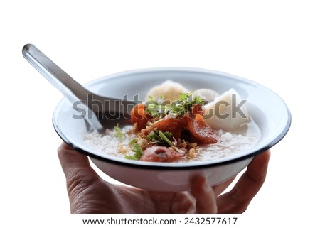 Woman hand holding rice porridge with pork and Fried Chinese sausage in white bowl isolated on white background