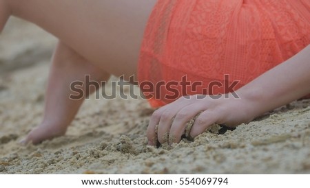 woman hand holding the sand close up