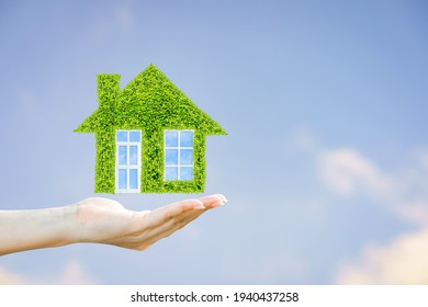 Woman Hand Holding Show Dream House Model With Working Capital Management On Blue Sky And Clouds Background, Business Investment And Loan For Real Estate Concept.