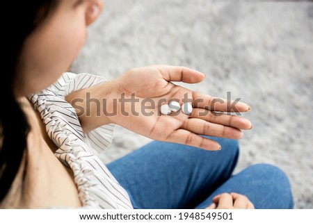 woman hand holding sleeping pills, melatonin ,overdose medicine concept 