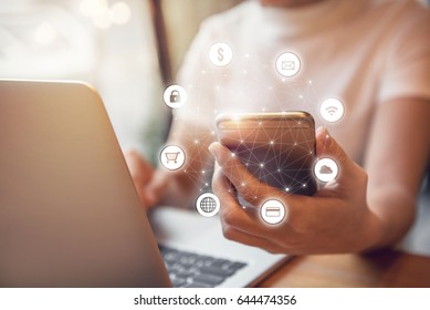 Woman hand holding smart phone with graphic icon multichannel online banking payment network communication - Powered by Shutterstock