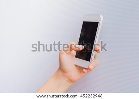 Woman hand holding a Smart Phone isolated on white background. Using for backgrounds or wallpapers.