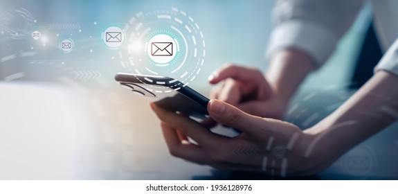 Woman hand holding smartphone and show email screen on application mobile in the office.