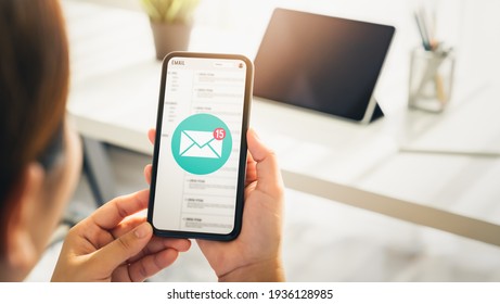 Woman Hand Holding Smartphone And Show Email Screen On Application Mobile In The Office.