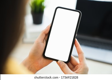 Woman hand holding smartphone and touching blank screen. Mockup of advertisement. - Shutterstock ID 1736921828