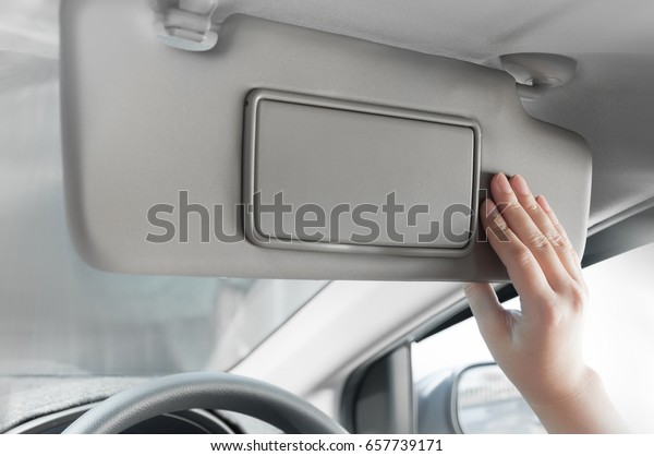 woman hand\
holding sun visor interior inside\
car
