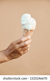 Woman Hand Holding Sweet Ice Cream In Wafer Cone Isolated On Beige Background Copy Space Photo. Delicious Dessert Icecream Balls In Crispy Cornet. Natural Ingredient Milk Food Product