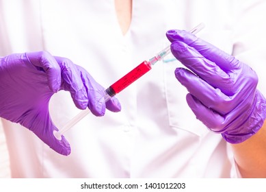 Woman hand holding syringe and ampule