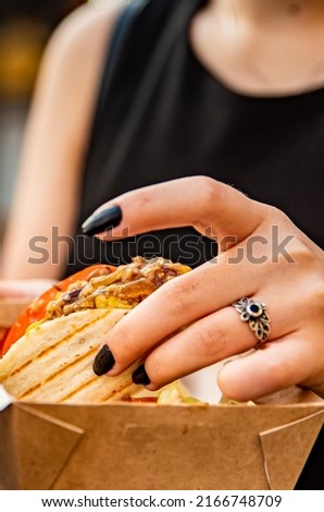 woman hand holding taco traditional in mexican food. street food