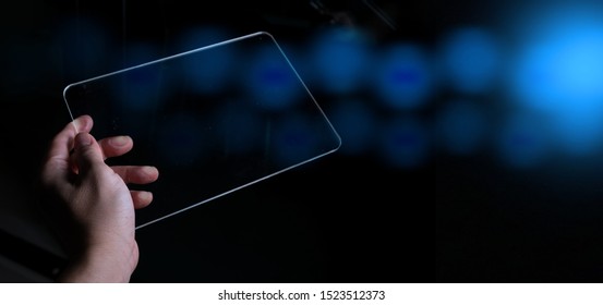 Woman Hand Holding And Touch Screen Smart Phone, Tablet Or Cellphone On Abstract Blurred Bokeh Dark Blue Background Background.