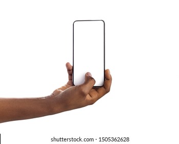 Woman hand holding and touching blank mobile phone screen with her thumb, isolated on white background
