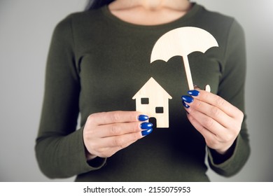 Woman Hand Holding Umbrella Cover Wooden Home Model. Real Estate