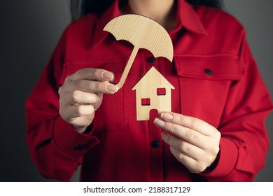 Woman Hand Holding Umbrella Cover Wooden Home Model. Real Estate

