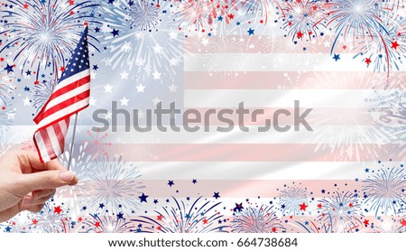Woman hand holding USA flag on fireworks background for 4 july independence day