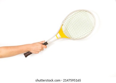Woman hand holding a vintage aluminum racket on a white background with copy space