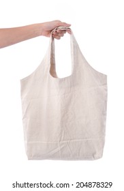 Woman Hand Holding White Cotton Bag On White Background