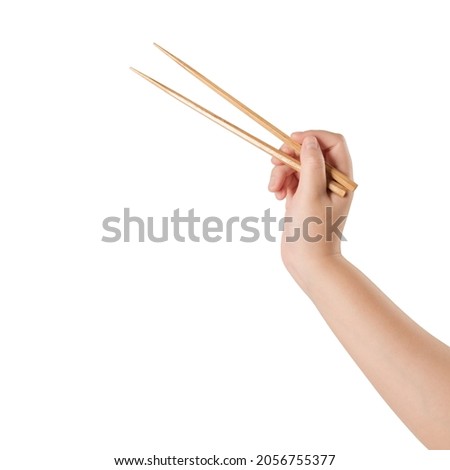 Woman hand holding wooden chopsticks isolated on white background.
