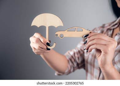 Woman Hand Holding Wooden Umbrella Over Car, Symbol For Car Protection