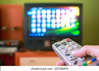 Woman hand holds remote control TV
