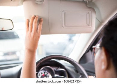 Woman Hand Holds The Sun Visor In The Car