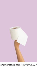 woman hand holds toilet napkin isolated on vertical background. Close-up roll of napkin. Space for text