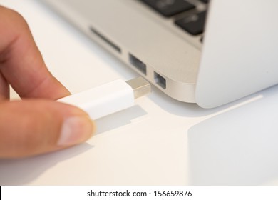 Woman Hand Inserting Thunderbolt Cable On Computer