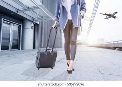 Woman With Hand Luggage In Airport