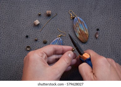Woman hand making earrings polymer clay  Hobby  handicraft background 